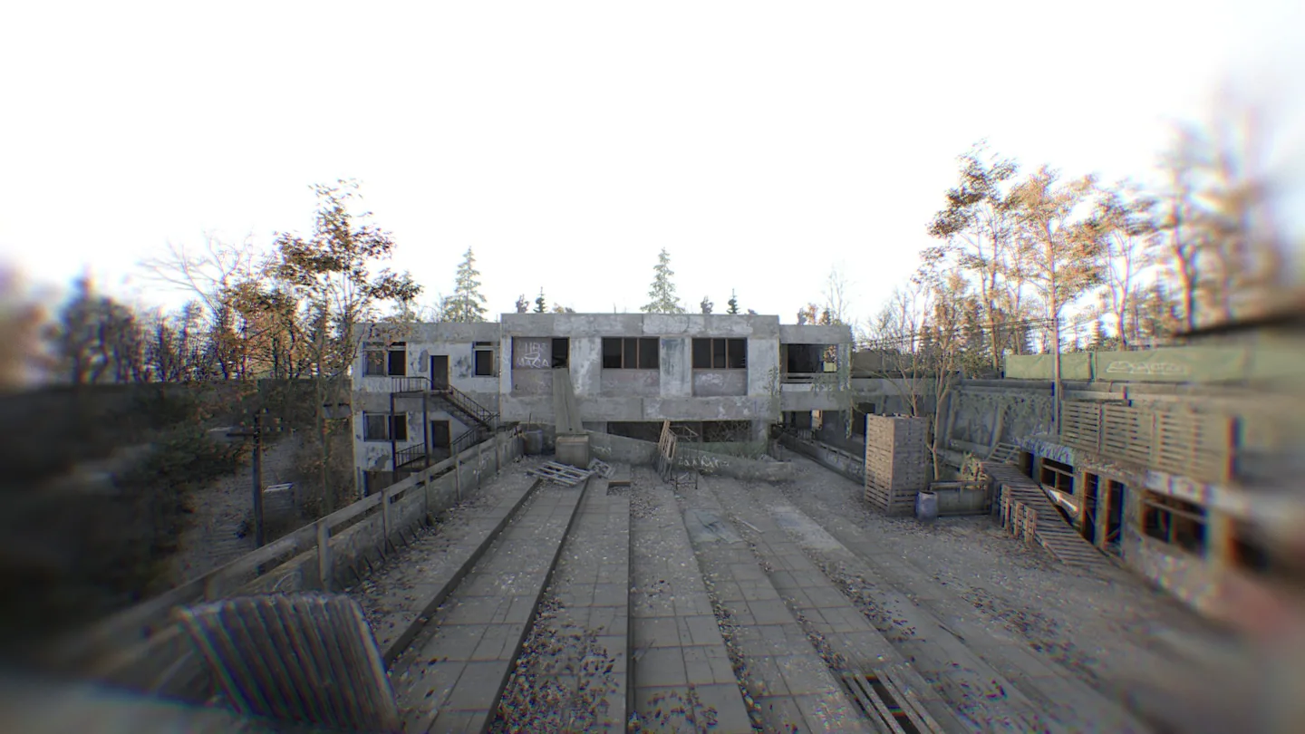 The open yard and unfinished concrete buildings.