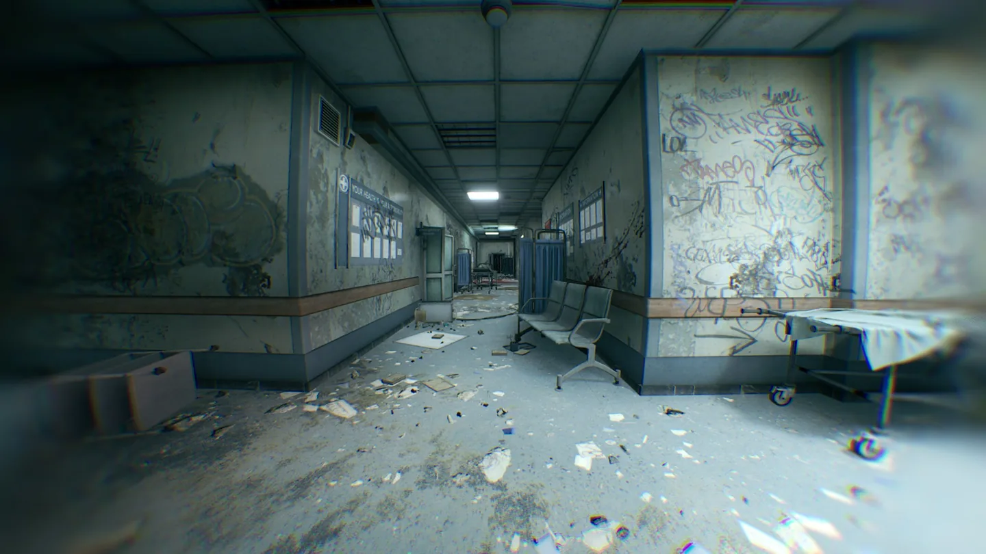 A hospital corridor lined with rooms and broken furniture.