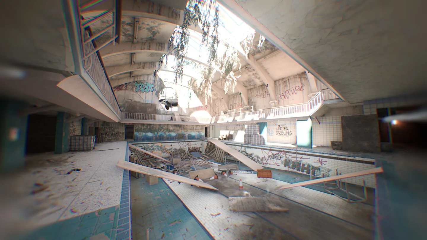 The empty pool beneath the damaged roof.
